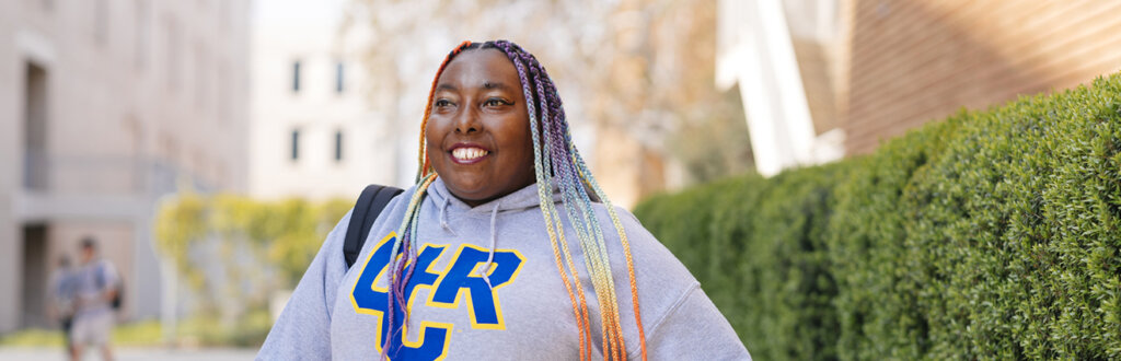 Person in UCR sweatshirt standing outside